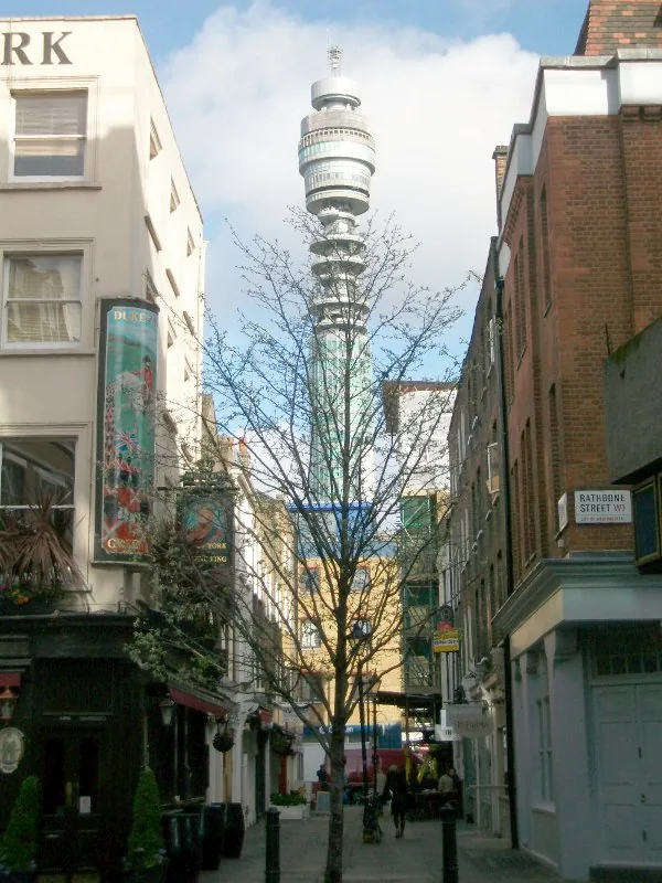 View of BT Tower from Rathbone Street looking through Charlotte Place in Fitzrovia. The street is in City of Westminster and London Borough of Camden.